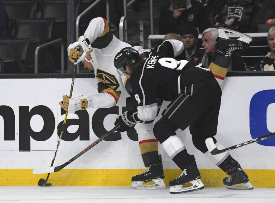 Los Angeles Kings right wing Adrian Kempe, of Sweden, right, checks Vegas Golden Knights right ...