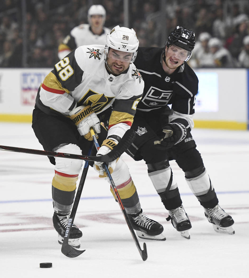 Vegas Golden Knights left wing William Carrier, left, and Los Angeles Kings left wing Austin Wa ...
