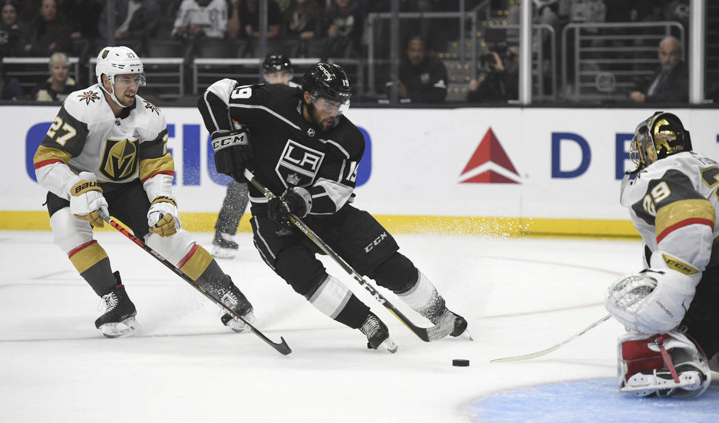 Los Angeles Kings center Alex Iafallo, center, shoots against Vegas Golden Knights goalie Marc- ...