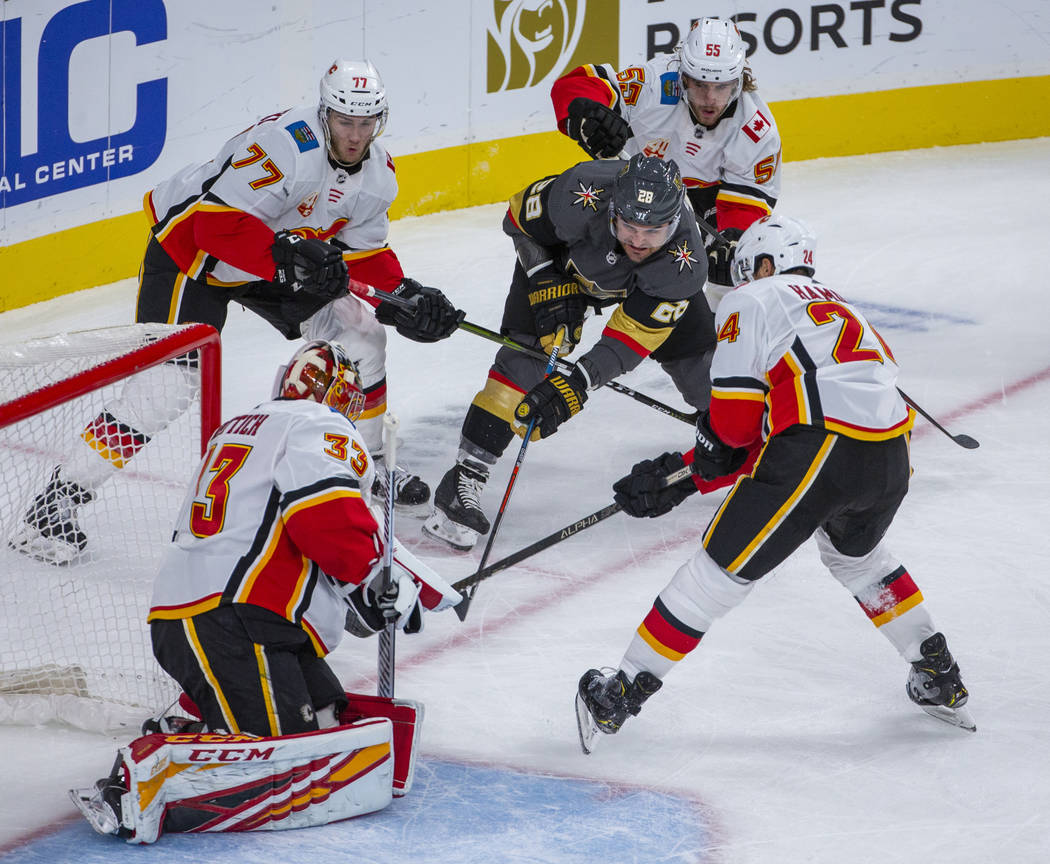 Vegas Golden Knights left wing William Carrier (28) penetrates the defense and shoots on Calgar ...