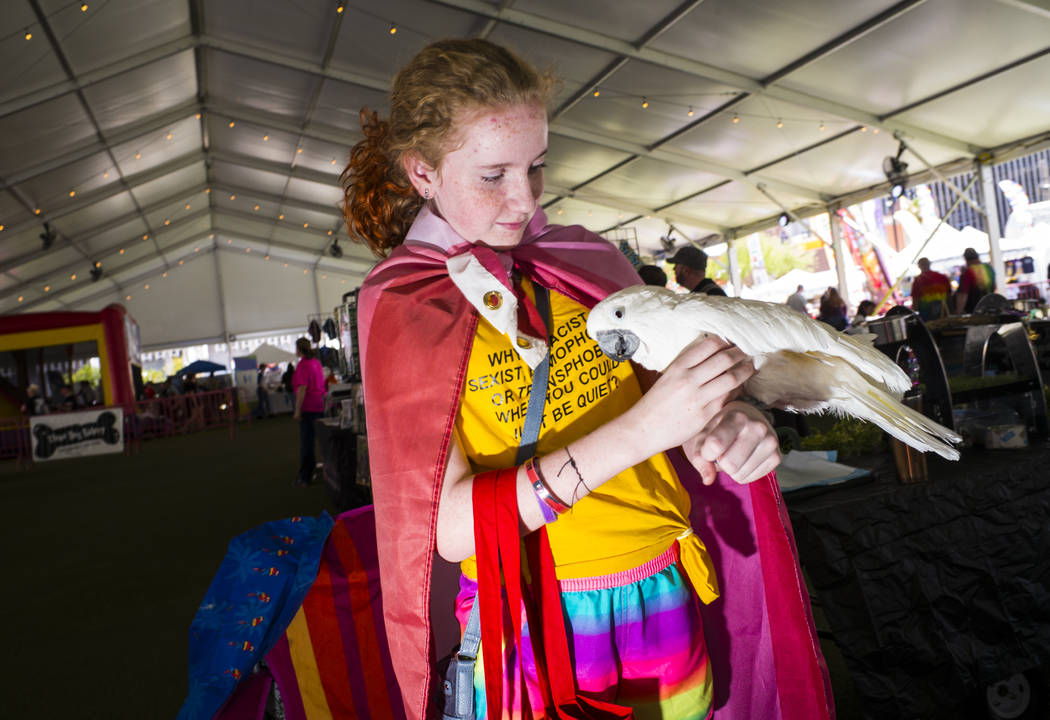 Twelve-year-old Marly Black, of Henderson, holds Coco Puff, an umbrella cockatoo, at the SouthW ...