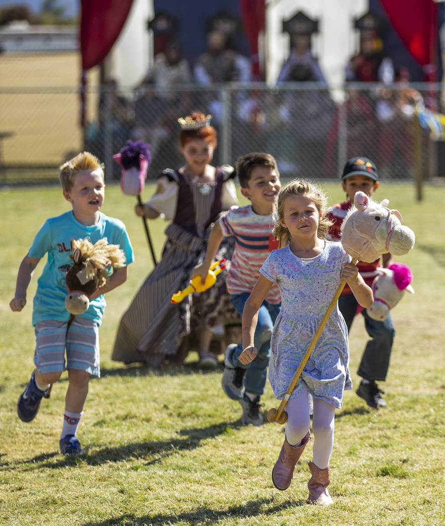 Children compete in a horse race as part of activities on the Field of Honor during the Age of ...