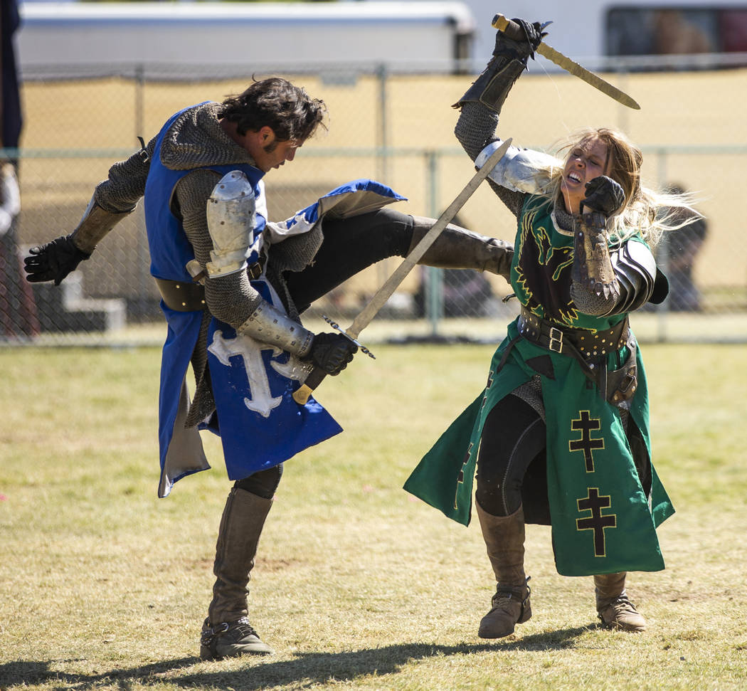 Sir Jeffrey the Blue Knight kicks Lady Andrea the Green Knight to the ground as they fight on t ...