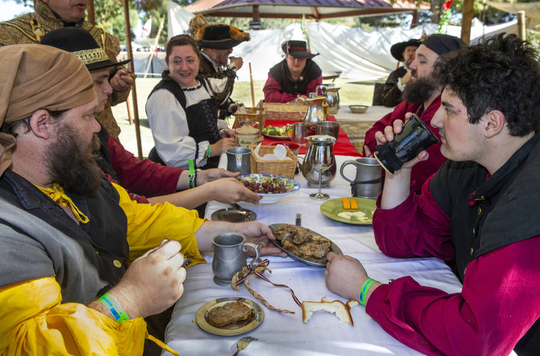 Members of La Orden de Santiago enjoy a group lunch during the Age of Chivalry Renaissance Fest ...