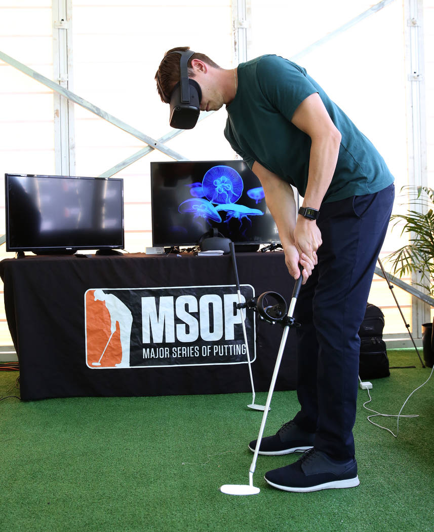 Robert Holzhauer, director of operation at Pro Putt, demonstrates how virtual reality putting i ...