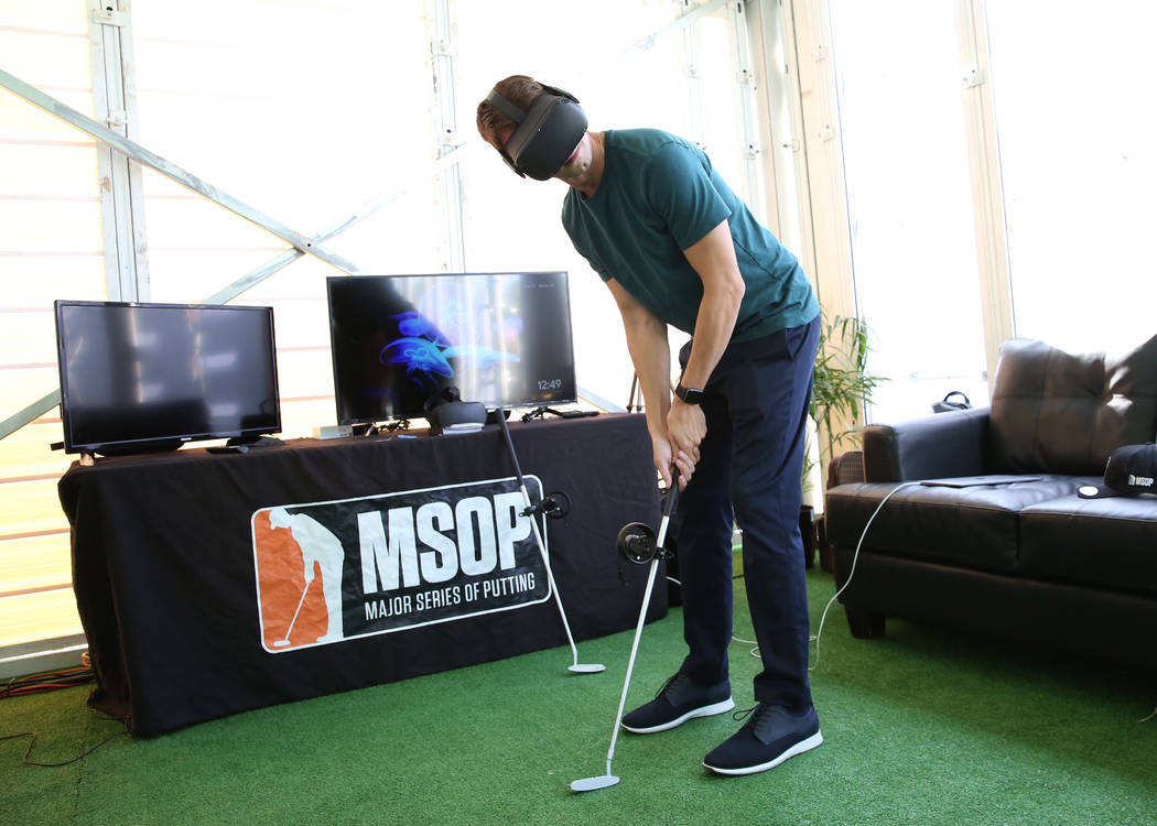 Robert Holzhauer, director of operation at Pro Putt, demonstrates how virtual reality putting i ...