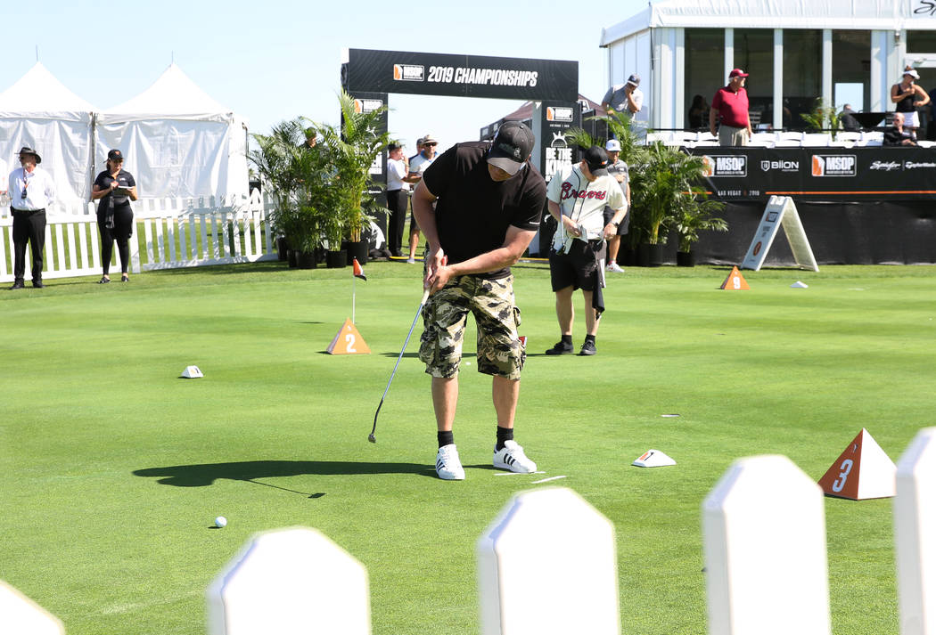 Ricard Lochner of Sweden, center, competes during the Major Series of Putting at Legacy Golf Cl ...