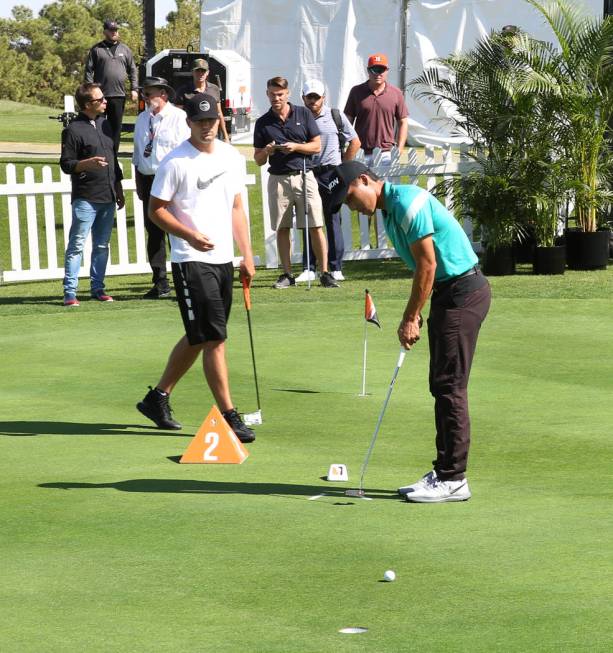 Matthew Marquez of Trinidad and Tobago, right, competes during the Major Series of Putting at L ...