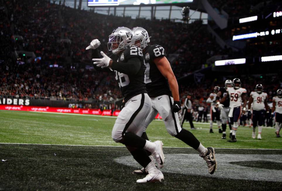 Oakland Raiders running back Josh Jacobs (28) celebrates his touchdown with tight end Foster Mo ...