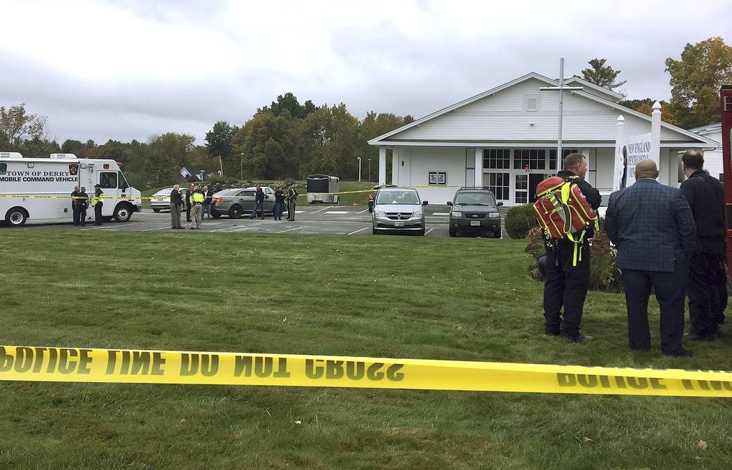 In this photo provided by WMUR-TV, police stand outside the New England Pentecostal Church afte ...