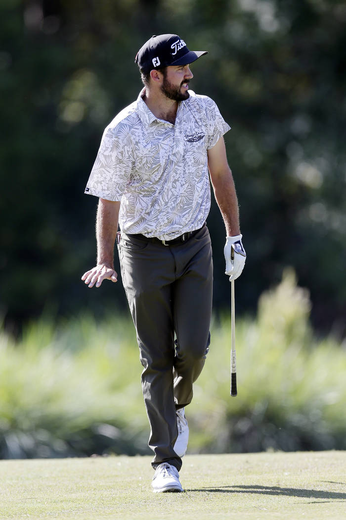 Mark Hubbard reacts as he watches his putts roll on the ninth green during the fourth round of ...