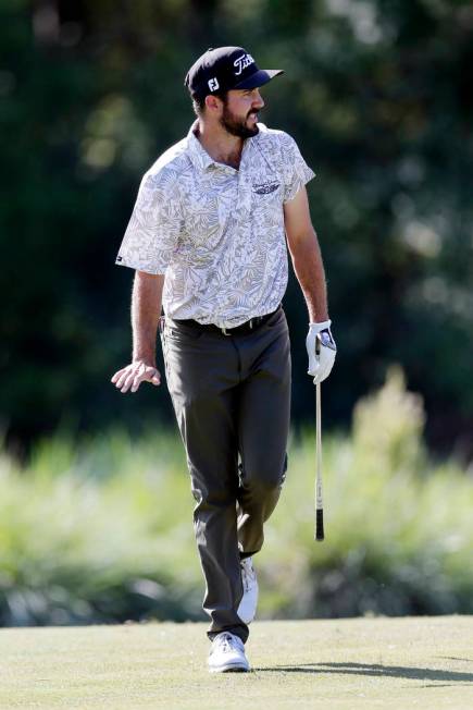 Mark Hubbard reacts as he watches his putts roll on the ninth green during the fourth round of ...