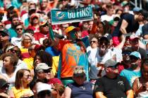 Miami Dolphins fans cheer the team, during the first half at an NFL football game against the W ...