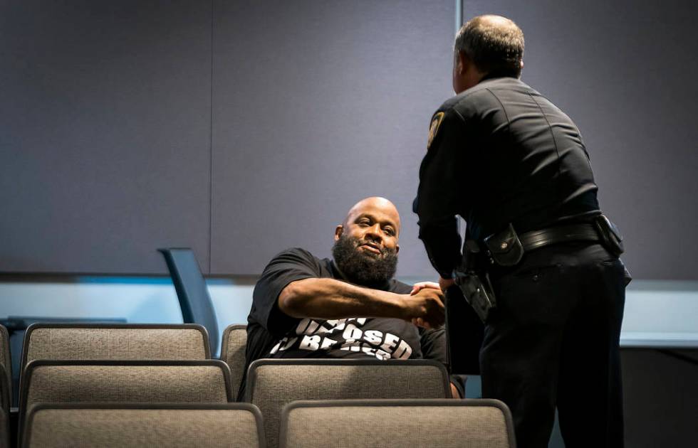 Fort Worth Police Lt. Brandon O'Neil shakes hands with Roger Foggle after addressing a news con ...