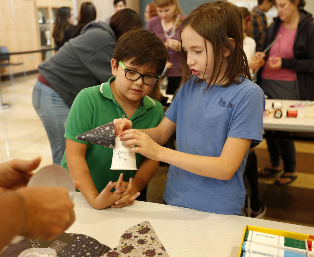 Liam Wilchen, 10, of Las Vegas, right, makes a fairy house with his bother Thorvaldr, 7, during ...