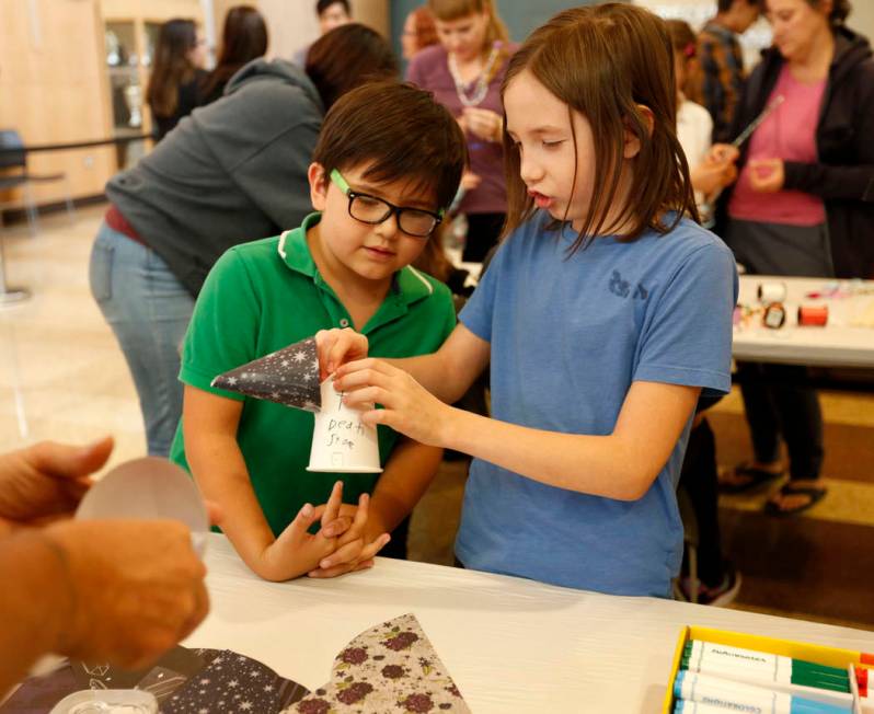 Liam Wilchen, 10, of Las Vegas, right, makes a fairy house with his bother Thorvaldr, 7, during ...