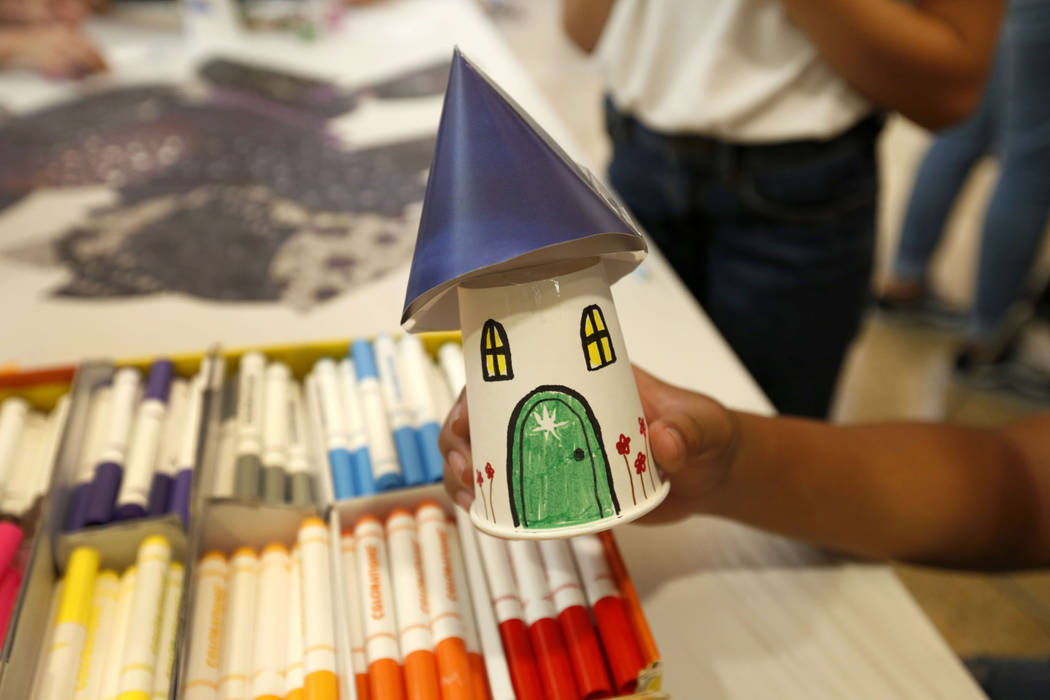 Instructor Hayden Gabriel of Las Vegas shows a fairy house during Mystic Fair at Windmill Libra ...