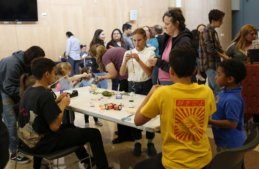 Children make wands during Mystic Fair at Windmill Library in Las Vegas, Friday, Oct.11, 2019. ...