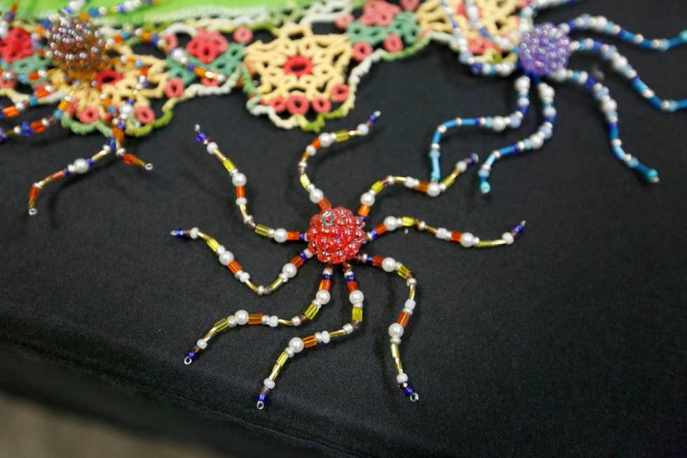 Karen Byrne, 74, of Third Eye Gifts in Las Vegas sells her beaded artworks during Mystic Fair a ...