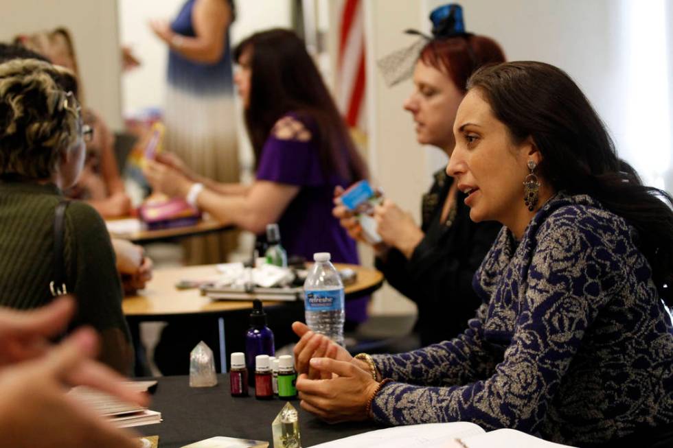 Local psychic Jennifer Pulcini talks with her client during Mystic Fair at Windmill Library in ...