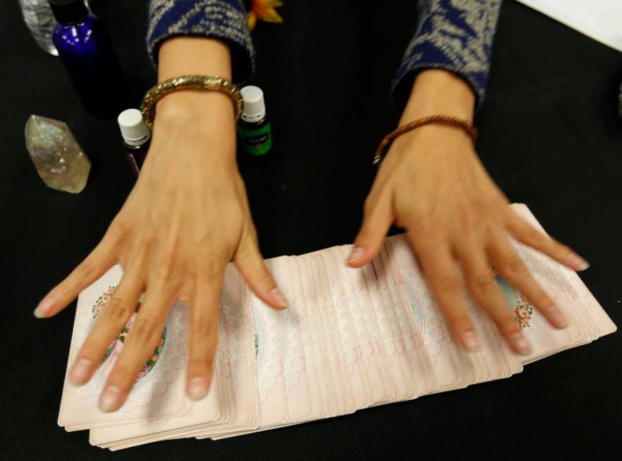 Local psychic Jennifer Pulcini shows her angel cards during Mystic Fair at Windmill Library in ...