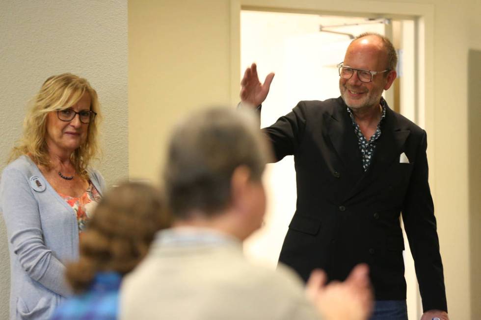 Stuart Holbrook, right, president of Theriault's, greets the crowd as Barbara Cennemo looks on, ...