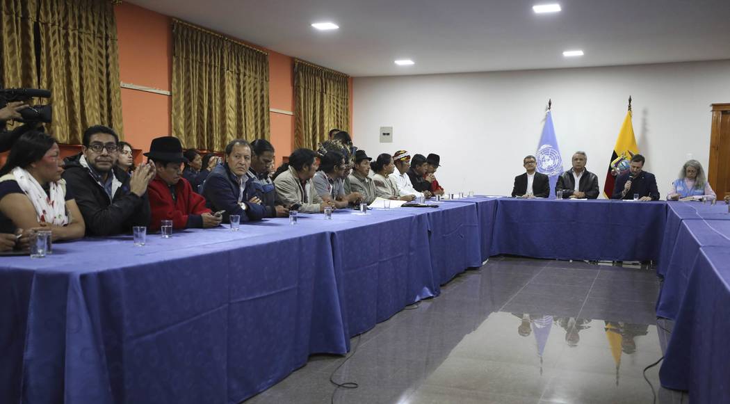 Indigenous leaders, left, attend negotiations with President Lenin Moreno, third from right, in ...