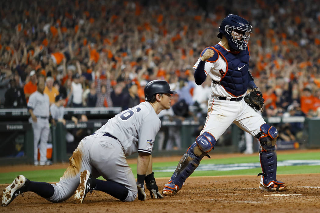 Houston Astros catcher Robinson Chirinos, right, celebrates after tagging out New York Yankees' ...