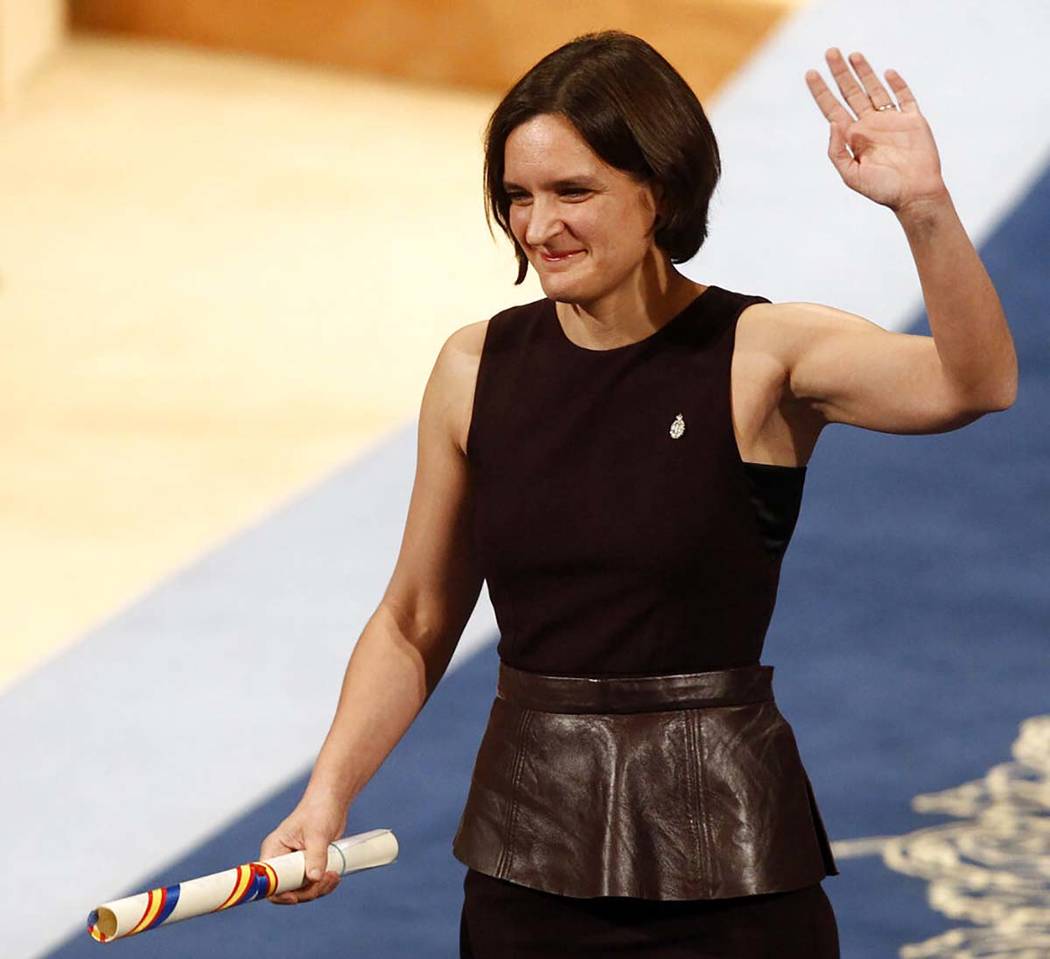 In a Friday Oct. 23, 2015, file photo, Esther Duflo of France waves after receiving the Princes ...