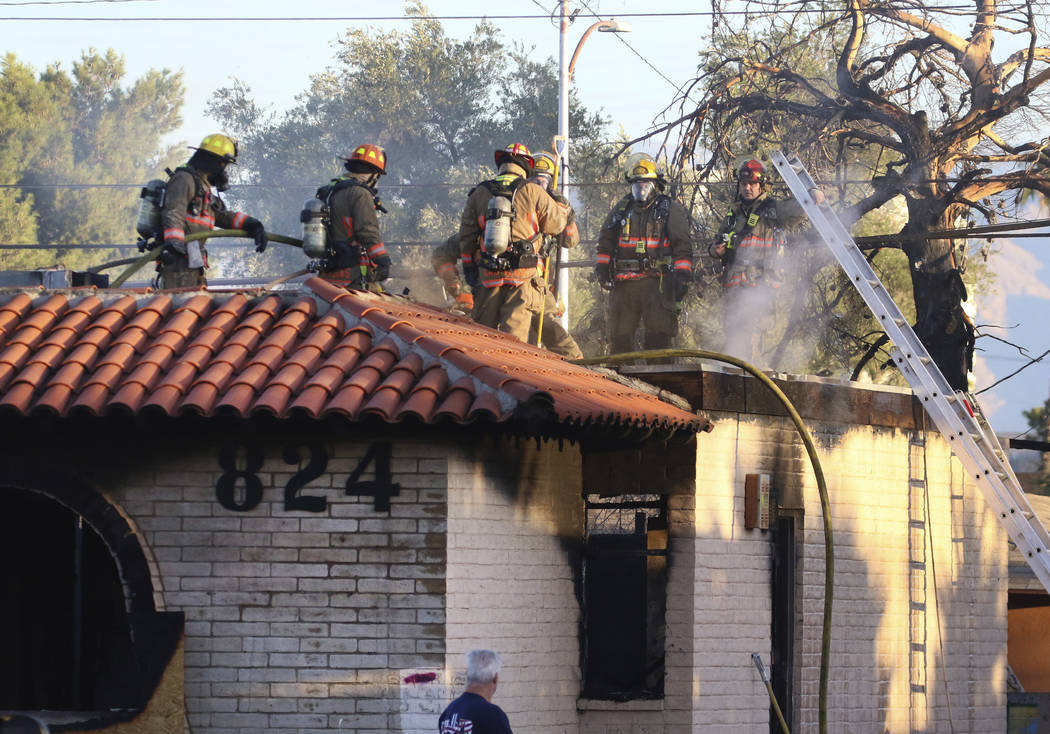 The Clark County and Las Vegas firefighters battle a fire in a commercial area at 824 E. Sahara ...