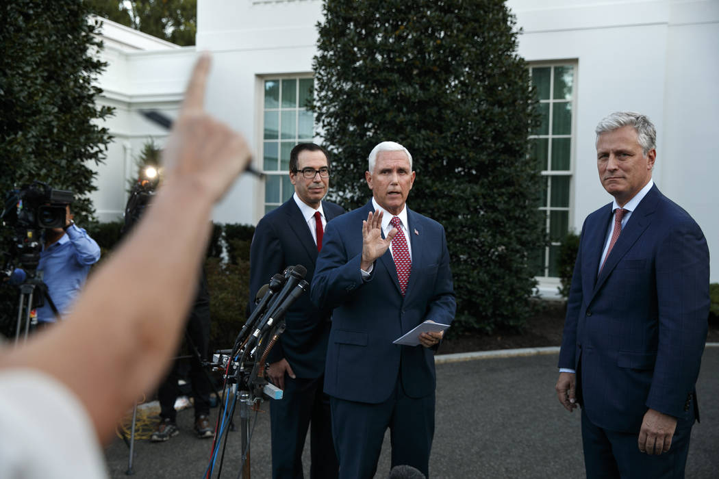 Vice President Mike Pence, center, with Treasury Secretary Steven Mnuchin, left, and White Hous ...