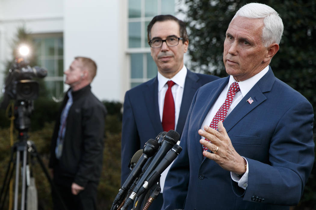 Vice President Mike Pence, with Treasury Secretary Steven Mnuchin, speaks to reporters outside ...