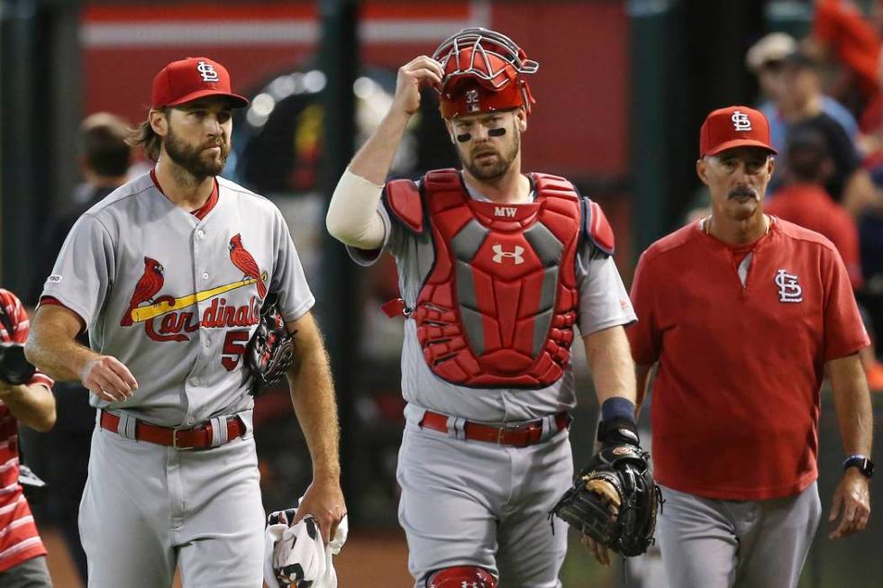 St. Louis Cardinals starting pitcher Michael Wacha, left, catcher Matt Wieters, middle, and pit ...