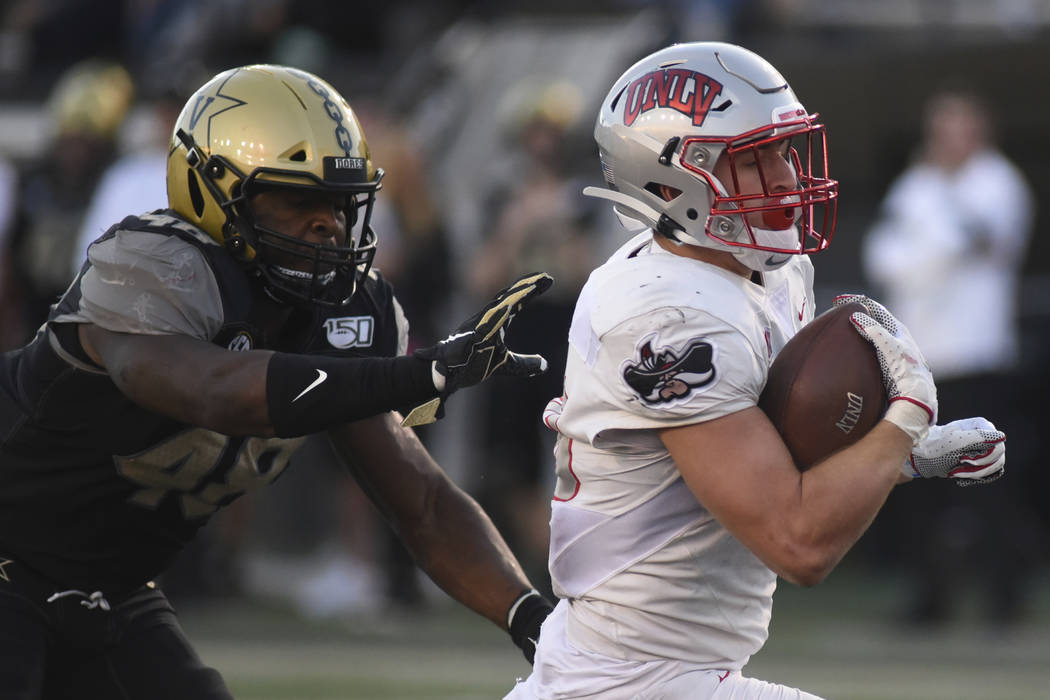 UNLV running back Chad Maygar, right, scores a touchdown past Vanderbilt linebacker Andre Mintz ...