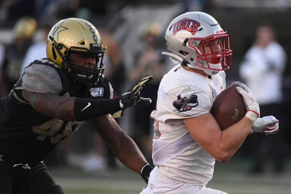 UNLV running back Chad Maygar, right, scores a touchdown past Vanderbilt linebacker Andre Mintz ...