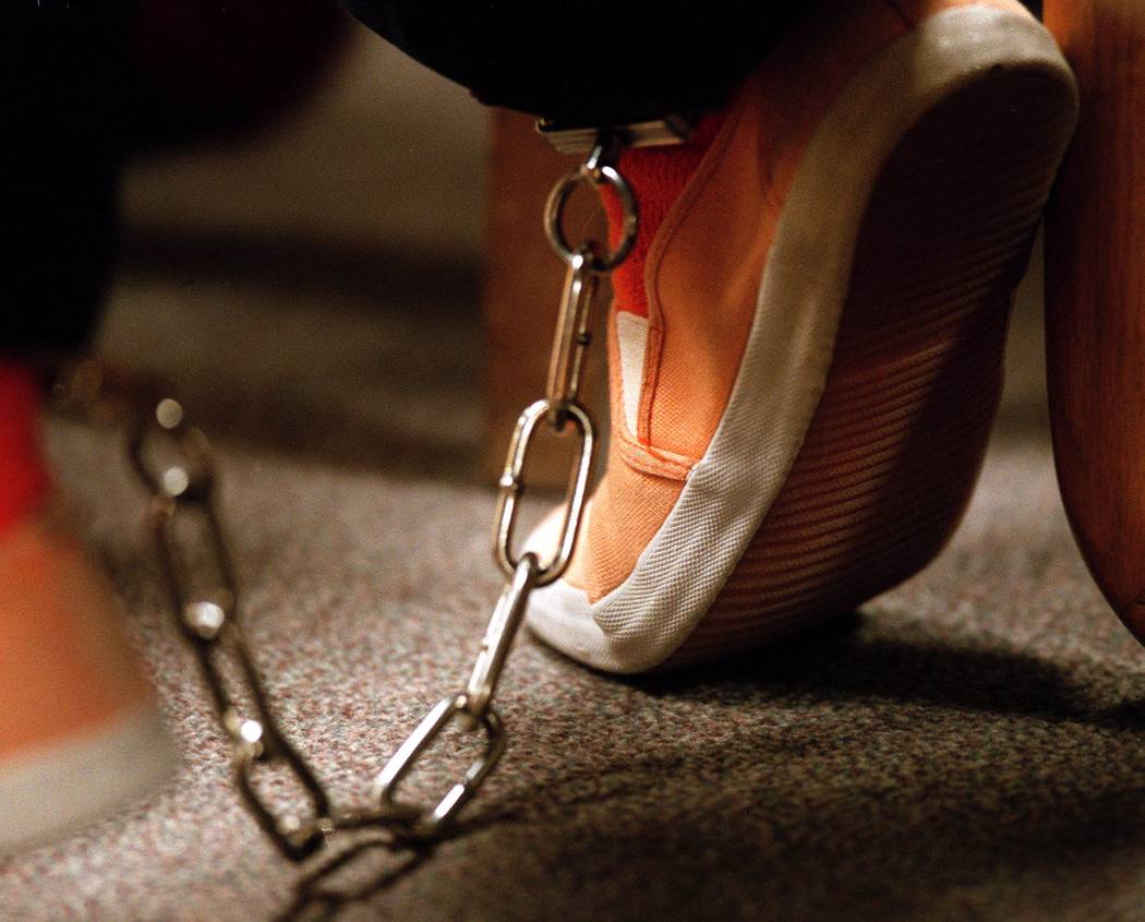 Margaret Rudin's legs are shackled while listening to District Attorney Stewart Bell testify ab ...