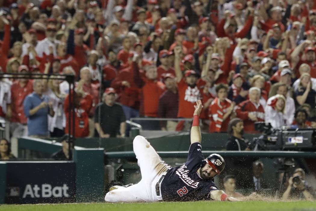 Washington Nationals' Adam Eaton scores on a hit by Anthony Rendon during the third inning of G ...