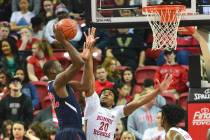 Fresno State Bulldogs forward Nate Grimes (32) takes a shot over UNLV Rebels forward Nick Blair ...