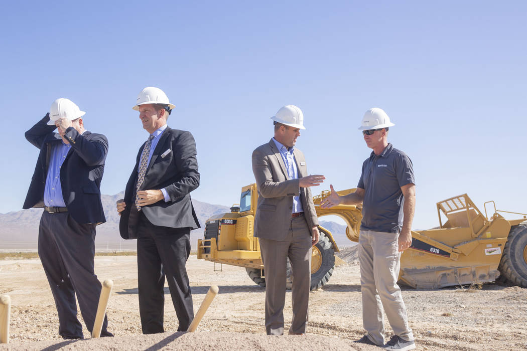 Individuals representing Lennar, Shea Homes and Woodside Homes celebrate the ground breaking of ...