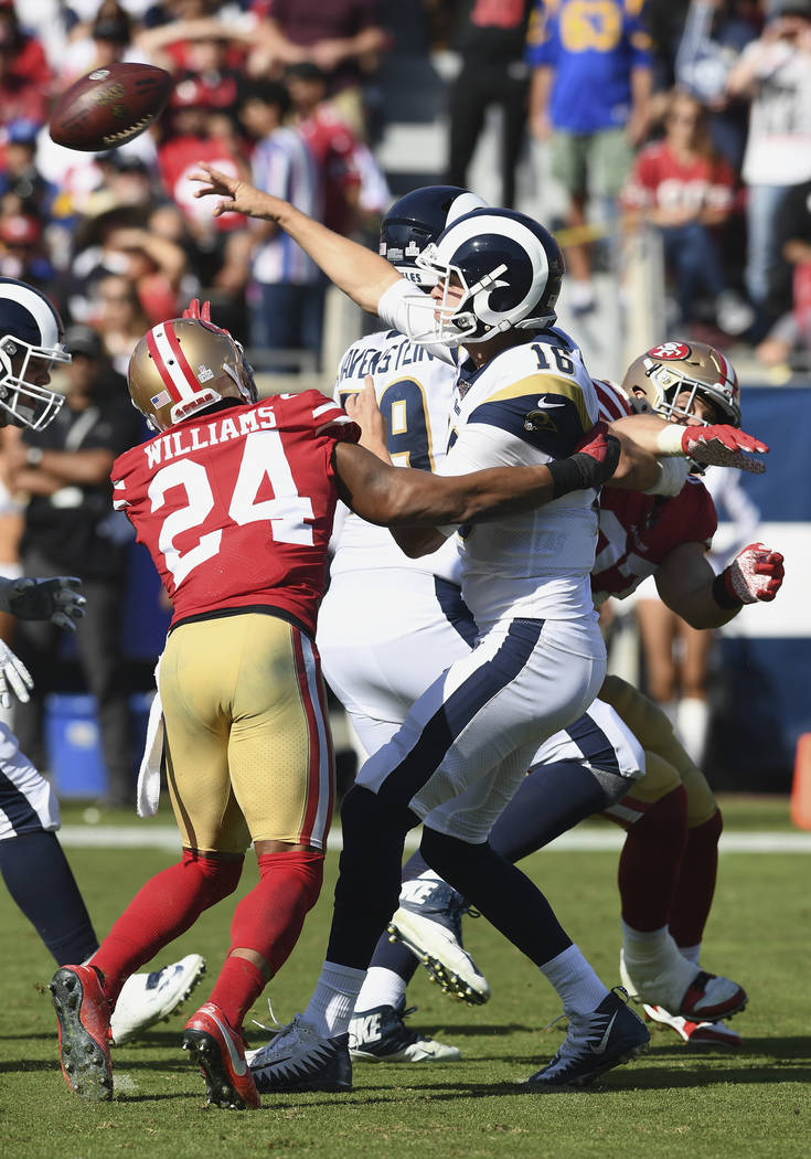Los Angeles Rams quarterback Jared Goff (16) passes the ball under pressure during an NFL footb ...