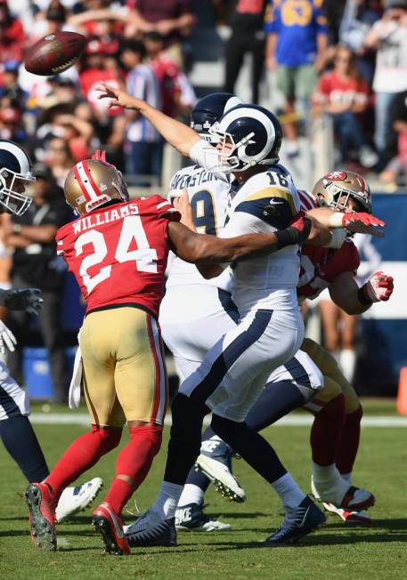 Los Angeles Rams quarterback Jared Goff (16) passes the ball under pressure during an NFL footb ...