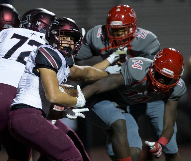 Faith Lutheran junior running back Marcos Canales (9) spins past Arbor View senior defensive en ...