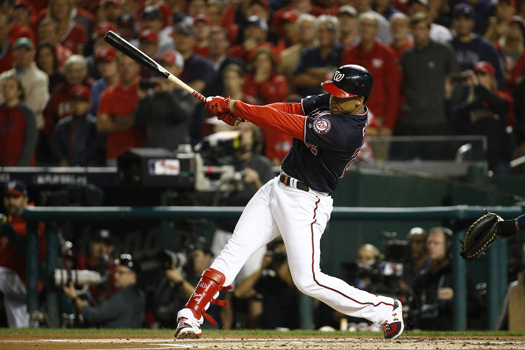 Washington Nationals' Juan Soto hits an RBI double during the first inning of Game 4 of the bas ...