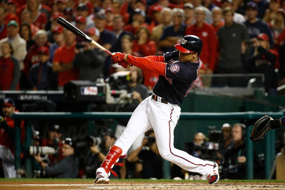Washington Nationals' Juan Soto hits an RBI double during the first inning of Game 4 of the bas ...