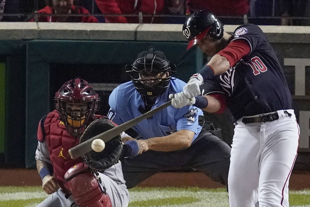 Washington Nationals' Yan Gomes hits a two-run scoring single during the first inning of Game 4 ...