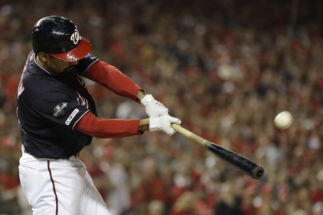 Washington Nationals' Anthony Rendon hits a sacrifice fly during the first inning of Game 4 of ...