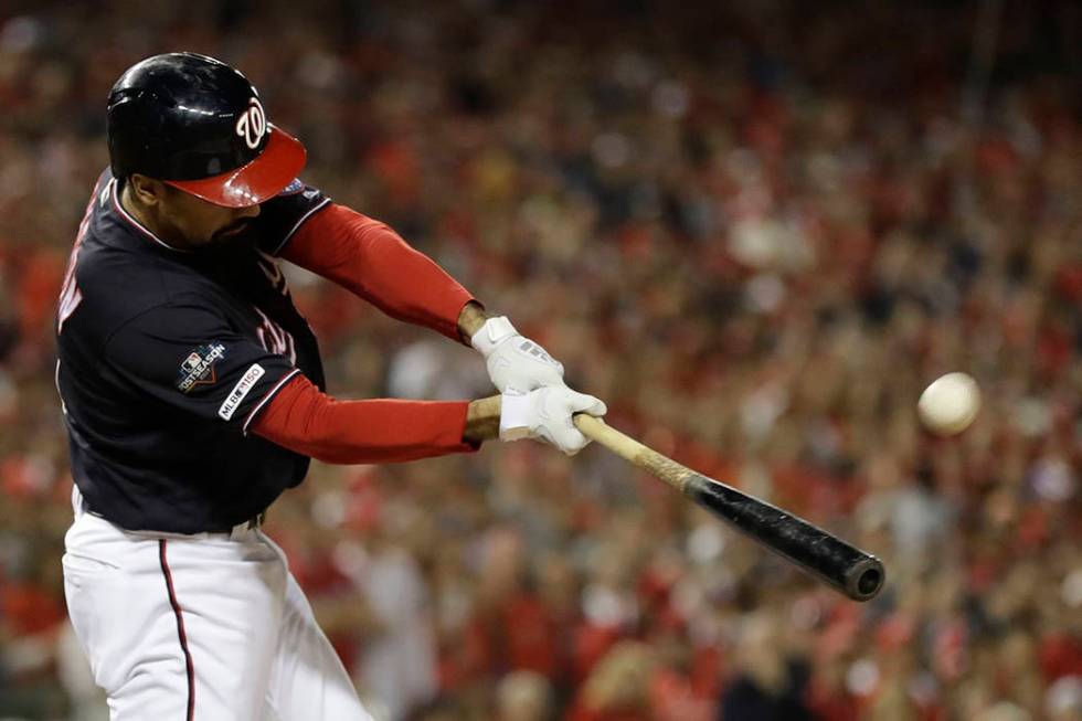 Washington Nationals' Anthony Rendon hits a sacrifice fly during the first inning of Game 4 of ...