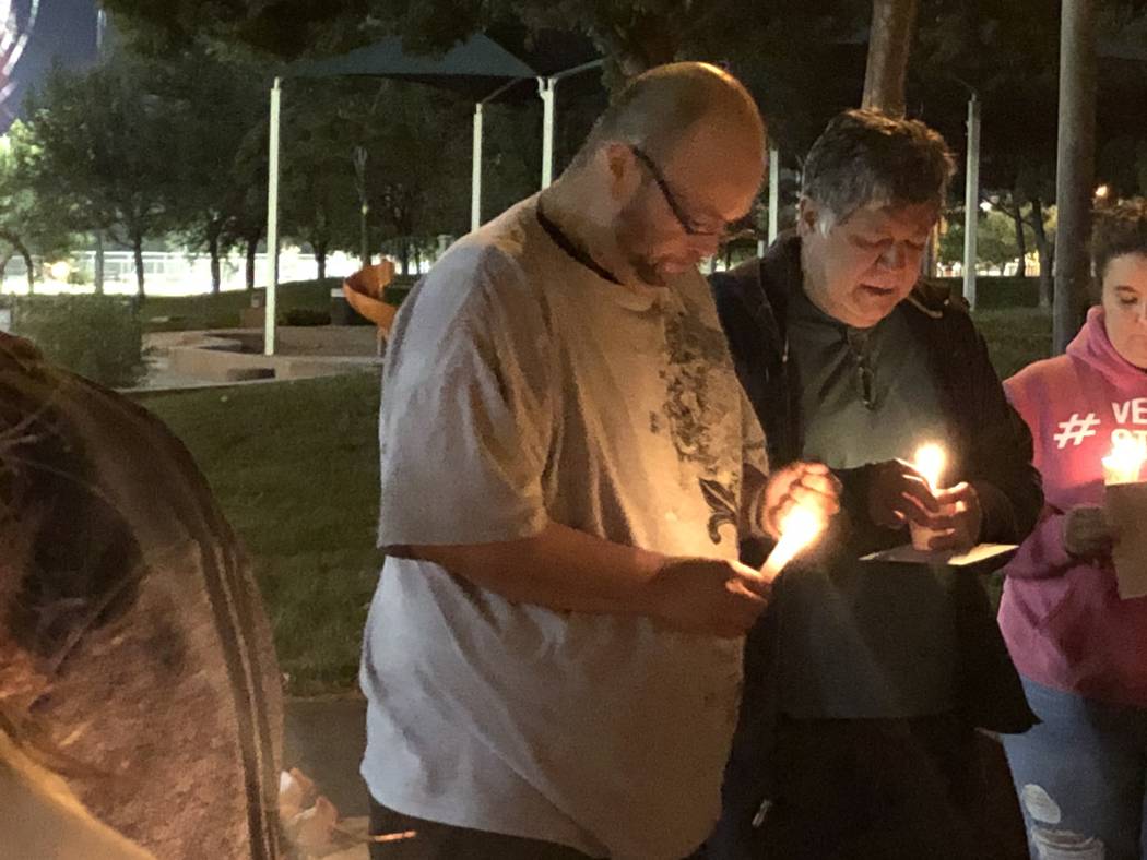 Levon Zeron, left, stands next to his father, Jose Zeron, during a vigil for the 42-year-old's ...