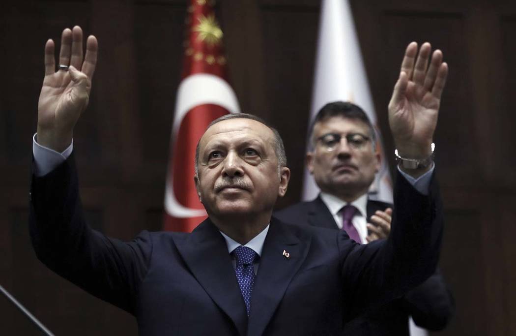 Turkish President Recep Tayyip Erdogan gestures as he addresses his ruling party legislators at ...