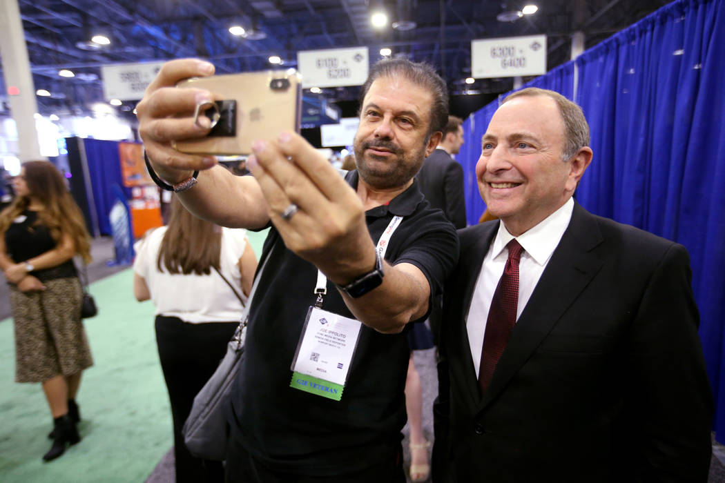 NHL commissioner Gary Bettman gets a photo with Joe Ippolito, of Newport Beach, Calif., after a ...
